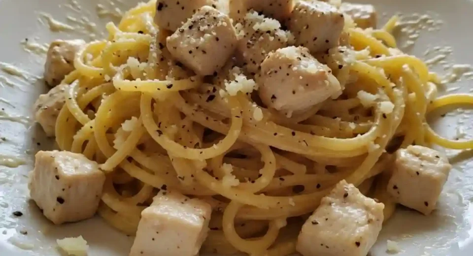 Chicken cubes in roasted garlic cream sauce over spaghetti.