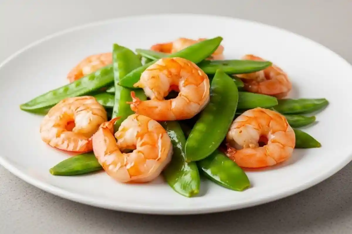 A quick and flavorful stir fry featuring tender shrimp and crisp snow peas in a savory garlic-ginger sauce.