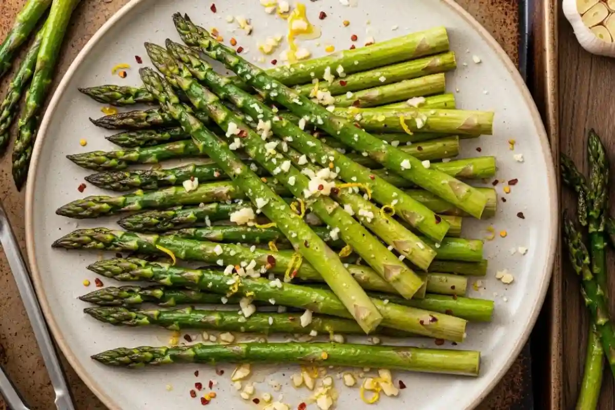 This oven-roasted asparagus side dish is coated in olive oil, garlic, lemon, and Parmesan